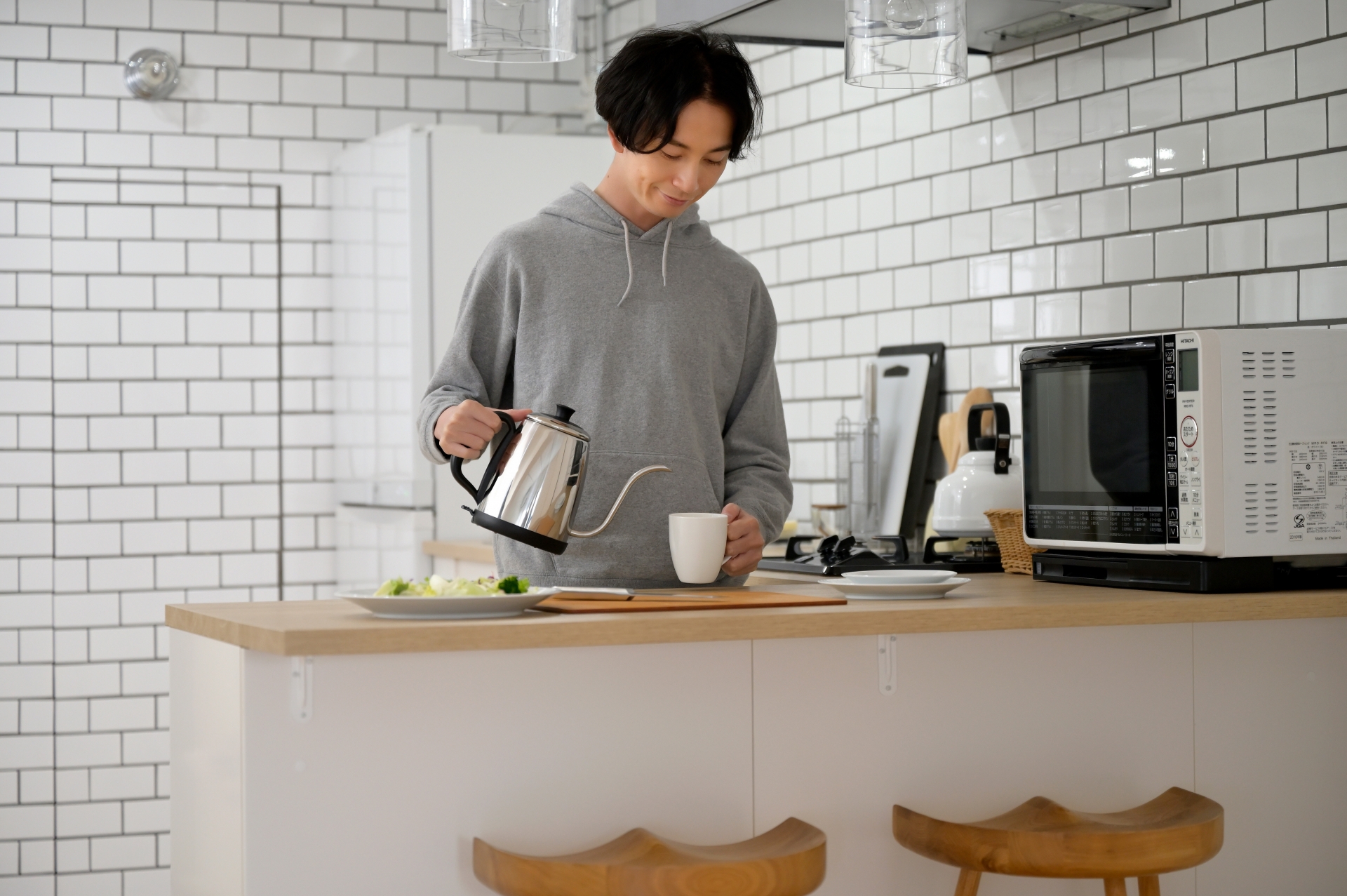 キッチンでコーヒーを飲む男性